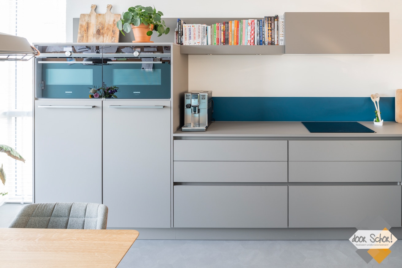 Een mat grijze keuken met een greeploos design
